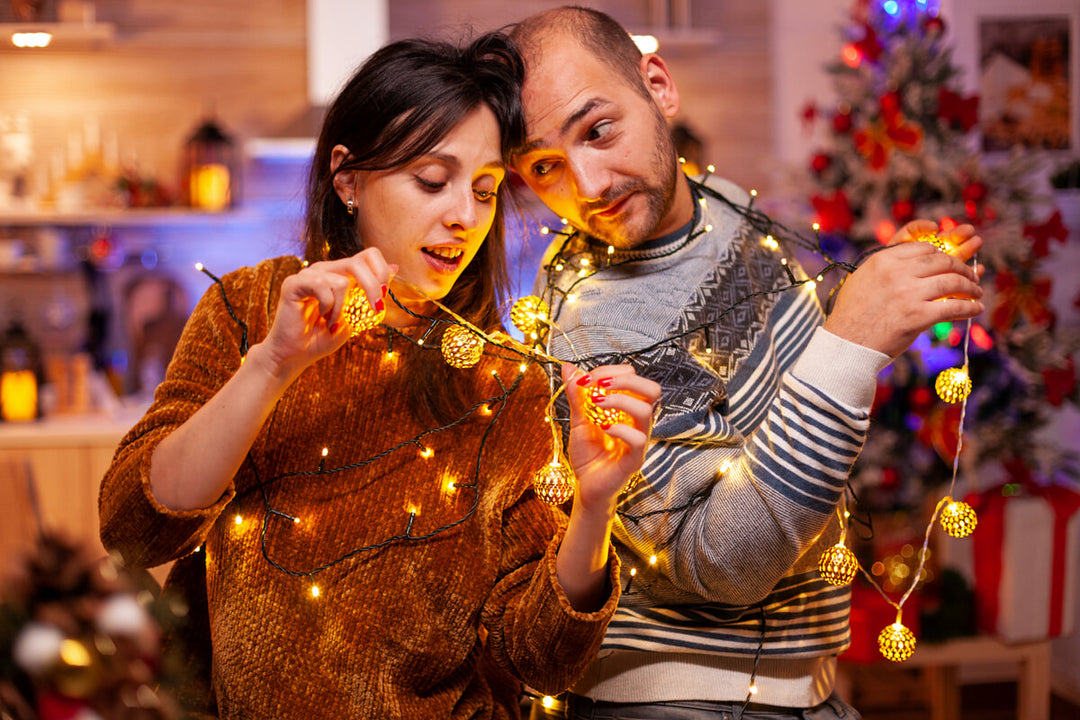 Couple stringing Christmas lights