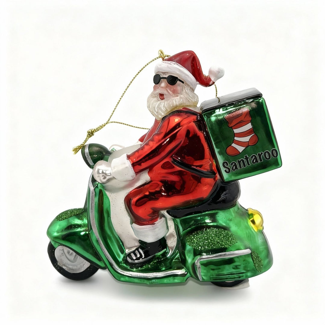 Handmade glass Christmas ornament featuring Santa Claus on a green scooter, exclusive Santa delivery decoration for edmodecor.com catalog
