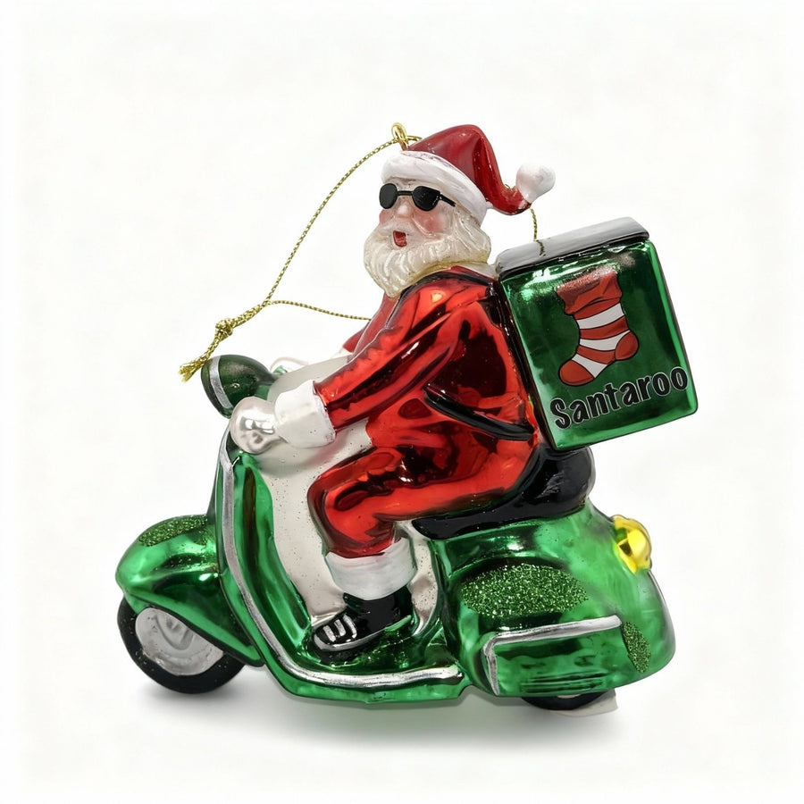 Handmade glass Christmas ornament featuring Santa Claus on a green scooter, exclusive Santa delivery decoration for edmodecor.com catalog