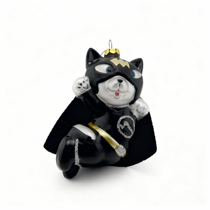 Glass Christmas ornament of a cute cat dressed as Batman with black costume and cape, displayed on a pure white background, perfect for holiday decoration and gift ideas.