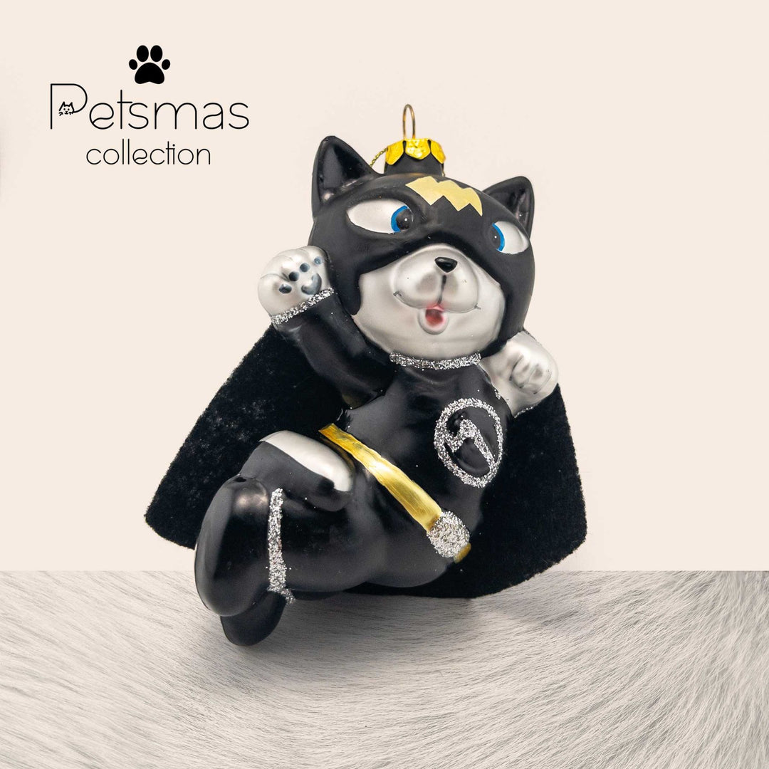 Cute cat Christmas ornament in Batman costume with black cape, glass holiday decoration