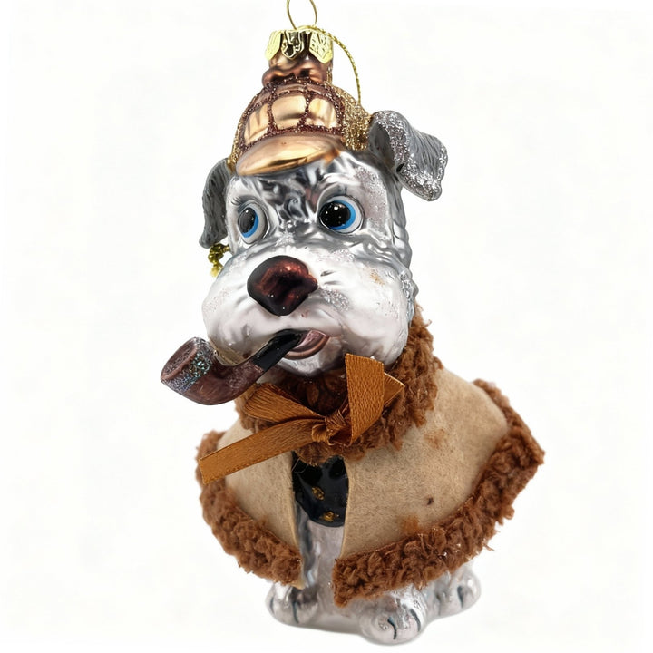 Handcrafted blown glass Christmas ornament featuring a Schnauzer dog dressed as detective with hat and pipe