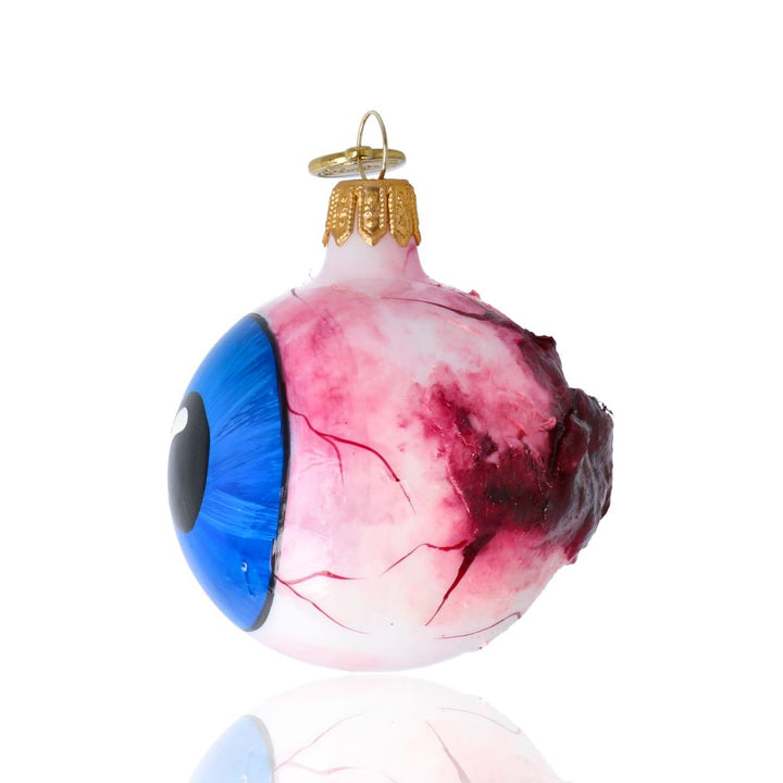 Back view of handcrafted glass eyeball ornament showing detailed optic nerve, spooky artisan Halloween glass decoration.