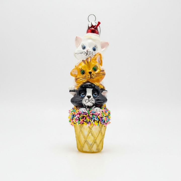 Front view of the three kittens stacked on an ice cream cone handmade glass ornament.