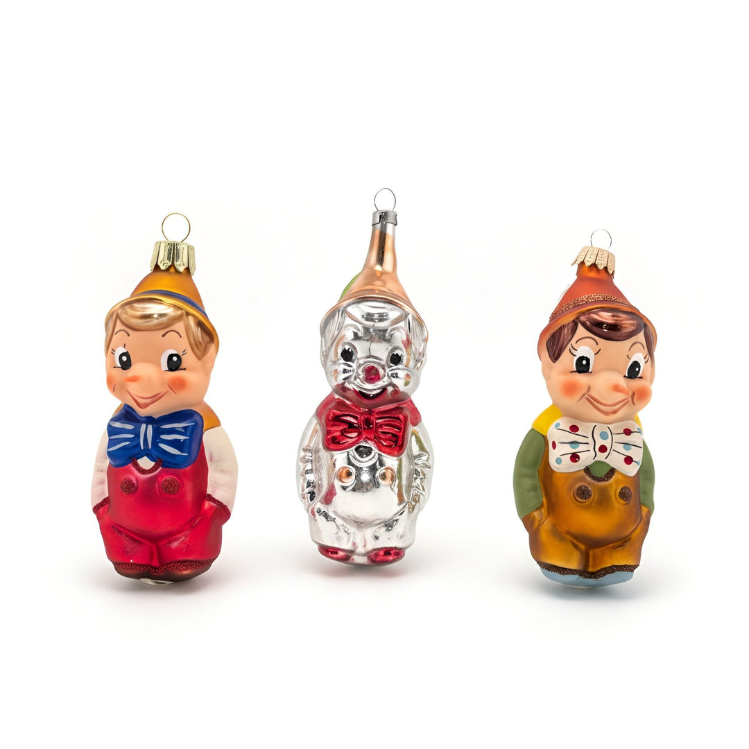 Front view of three Pinocchio glass Christmas ornament variants by Edmo