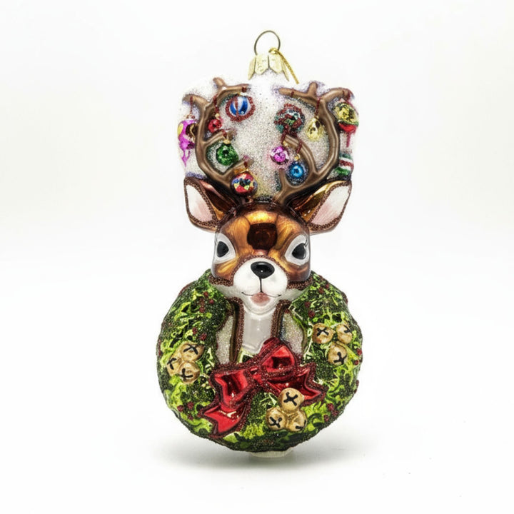 Traditional Christmas wreath glass ornament with reindeer head.