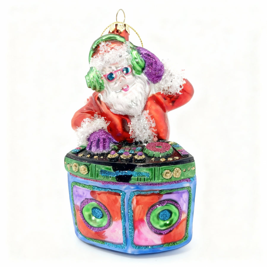 Handcrafted glass Santa Claus DJ Christmas ornament at the console.
