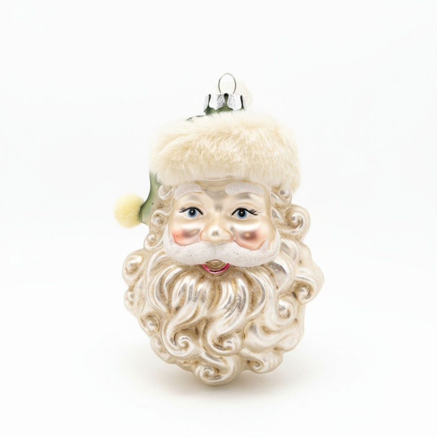 Handcrafted glass ornament of Santa Claus head with green hat and fur-trim detail.
