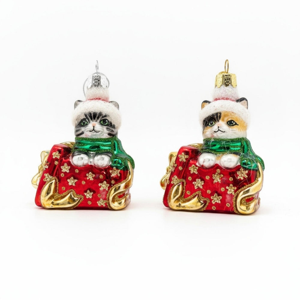 Handcrafted glass ornament of a kitten popping out of a Christmas gift box